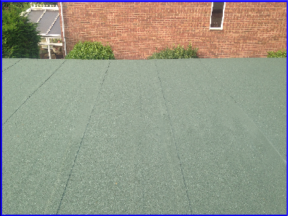Image of flat roof finished in green mineral felt